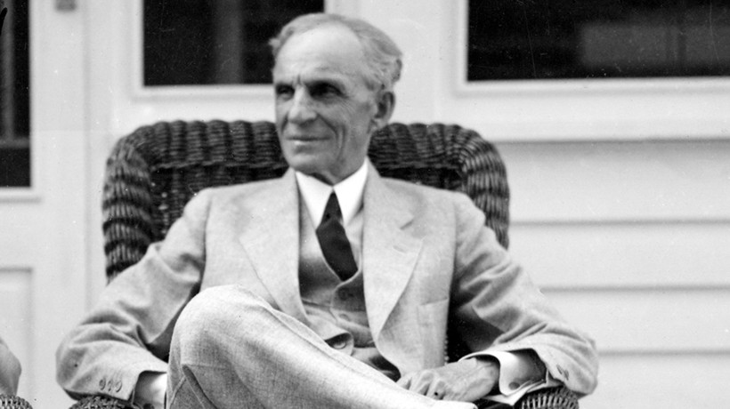 Black and white photo of Henry Ford sitting in a chair