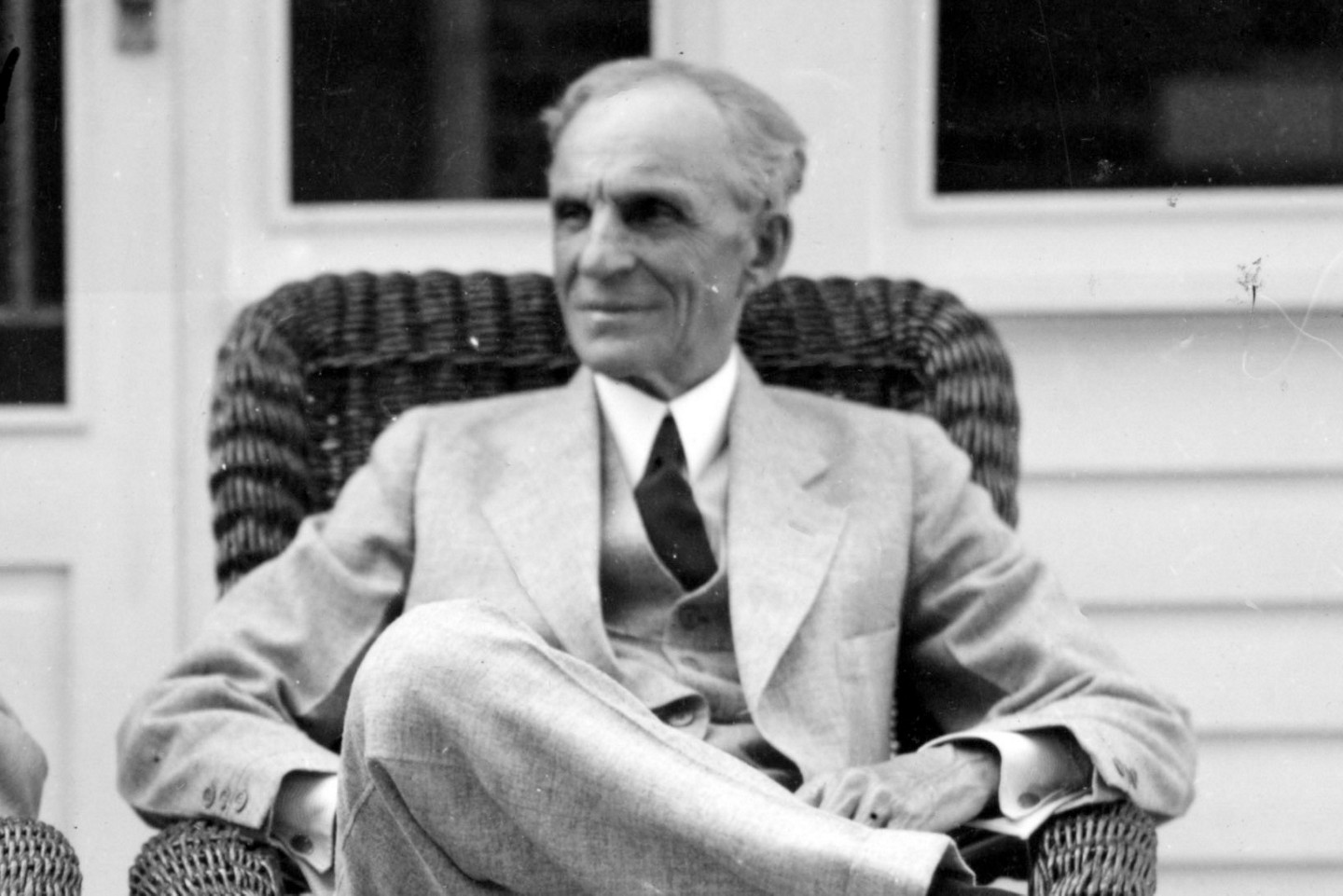Black and white photo of Henry Ford sitting in a chair