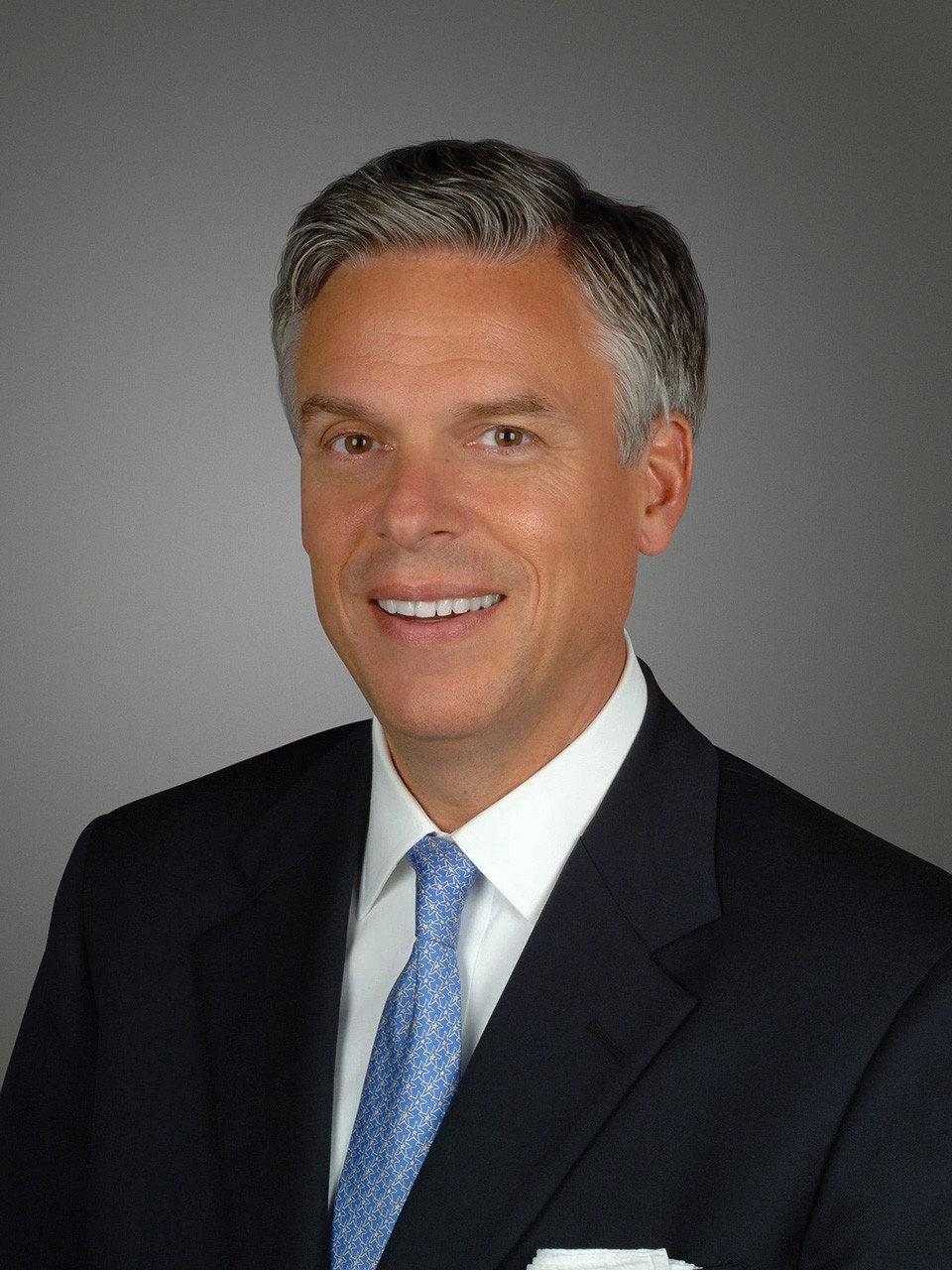 Jon Huntsman Jr., in a studio, smiles to camera
