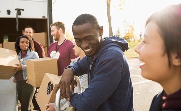 Ford employees working together to move boxes