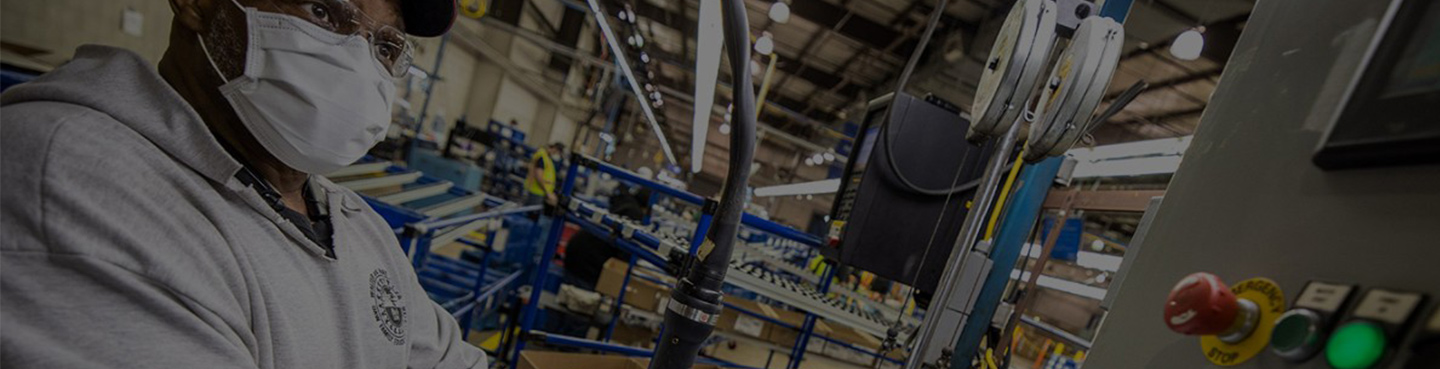 man wearing mask working at machine