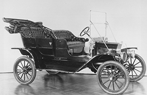 A black and white photo of a Model T car