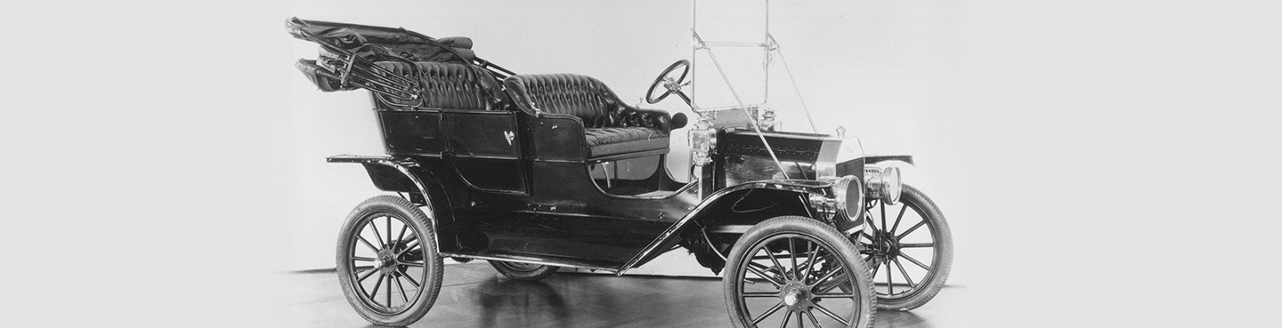 A black and white photo of a Model T car