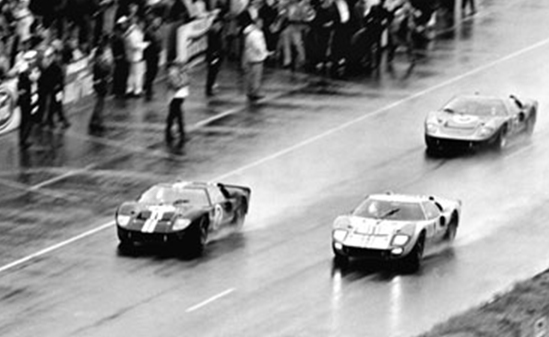 Black and white photo of 3 Ford GT40s at the 24 Hours of Le Mans race