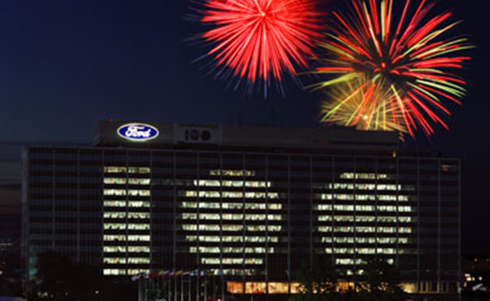 Color photo  Ford Headquarters building with fireworks in the background