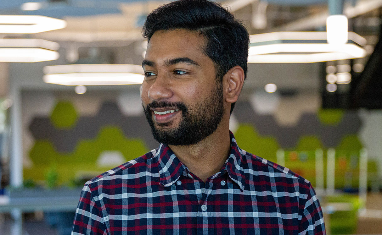 Male employee smiling for camera