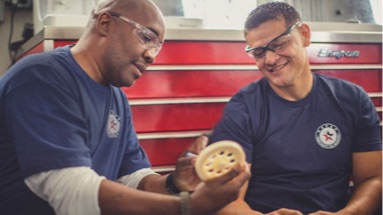 Two men in a military workshop