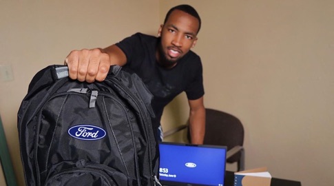 Student in internship program holding Ford bag
