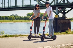 Couple riding on SPIN electric scooters