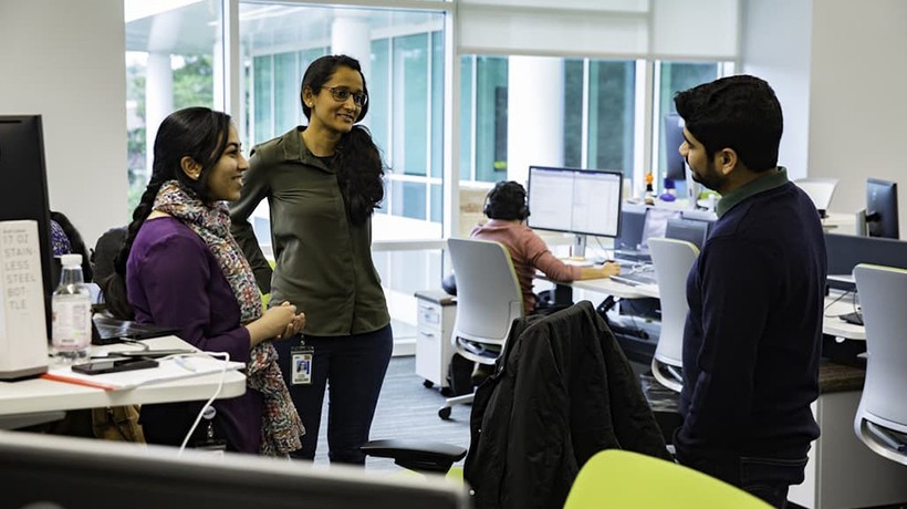 Employees chatting in Greenfield Labs workspace