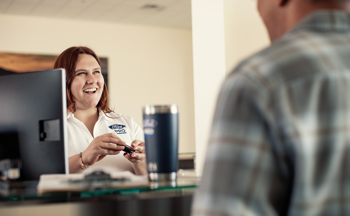 A Ford Pro employee helping a customer