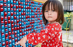 Little girl with blue and red wall